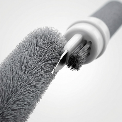 Macro view of KeyBudz AirCare 1.5 cleaning tools: a fine metal tip and dense fiber brush bristles.